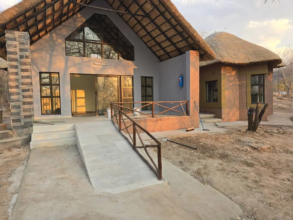 A finished lodge with its access ramp and timber rail